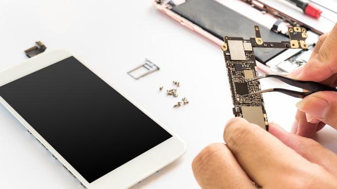 A Person Repairing A Mobile Phone